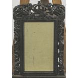 A 19th century carved oak wall mirror, the frame with foliate pierced decoration,