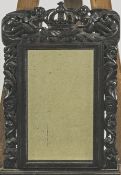 A 19th century carved oak wall mirror, the frame with foliate pierced decoration,