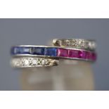 A white metal 'night and day' ring set half and half to central band with square cut sapphires and