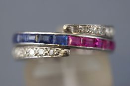 A white metal 'night and day' ring set half and half to central band with square cut sapphires and