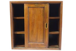 A Victorian mahogany cupboard, fitted two sliding doors enclosing shelves,