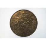 A Japanese bronze mirror, cast with cranes and trees,