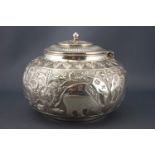 An Indian white metal covered bowl, the bellied body chased and engraved with tigers,