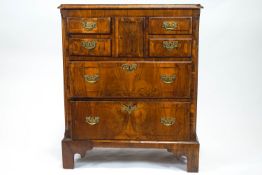 An early George III walnut chest of drawers, with cross banded decoration,