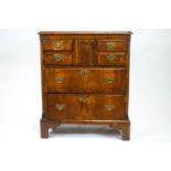 An early George III walnut chest of drawers, with cross banded decoration,
