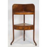 A 19th century mahogany corner wash stand, with raised back above a bowl recess,