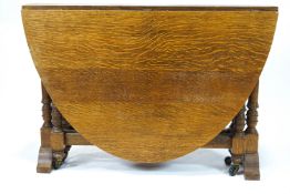 An oval oak gate leg table,