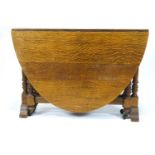 An oval oak gate leg table,