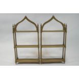 A pair of painted three tier hanging wall shelves,