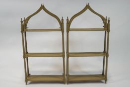 A pair of painted three tier hanging wall shelves,