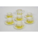 A Solian ware coffee set with six cups and saucers and a jug, decorated with yellow foliate motifs,
