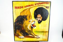 A Circus advertising sign for 'Hindu Animal Hypnotist', painted on wooden planks,