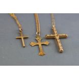 A collection of three cross pendants each fitted to chains together with two additional loose