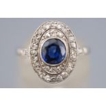 A white metal cluster ring set with a central deep blue sapphire NB: Sapphire untested however