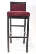 A bar stool, with upholstered seat and back,