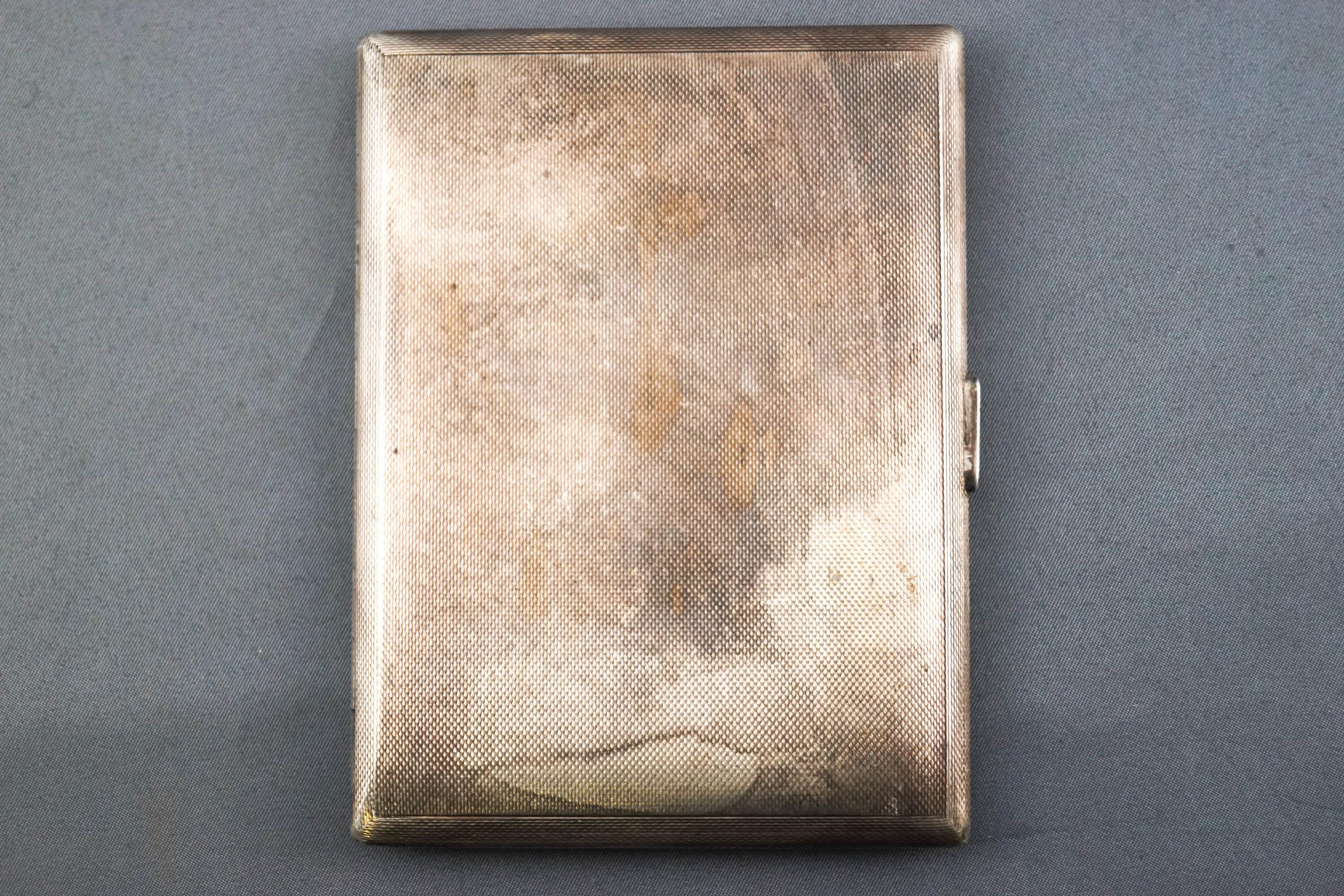 A plain rectangular form engine turned silver cigarette case with gilt interior, Garrard & Co,