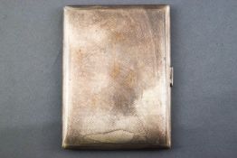 A plain rectangular form engine turned silver cigarette case with gilt interior, Garrard & Co,