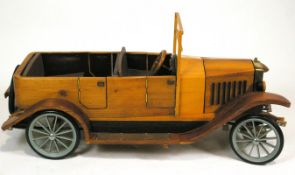 A wooden scale model of a Volvo OV4 car,