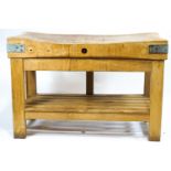 A pine butcher's block, the scrubbed top with usual signs of wear,