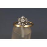 A yellow and white metal cluster ring. Set with seven old European cut diamonds.