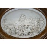 A 19th century Parian plaque, signed Justin, intricately detailed with a Crucifixion scene,