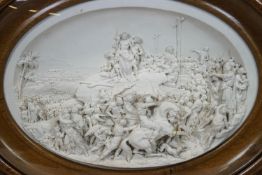 A 19th century Parian plaque, signed Justin, intricately detailed with a Crucifixion scene,