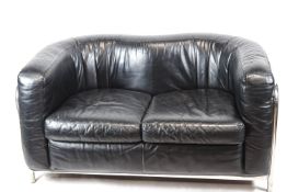 A Zinotla sofa with chrome frame enclosing a leather shaped back and cushion,