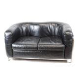 A Zinotla sofa with chrome frame enclosing a leather shaped back and cushion,