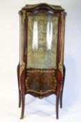 A French display cabinet, the part glazed door with panel of a courting couple,
