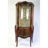 A French display cabinet, the part glazed door with panel of a courting couple,