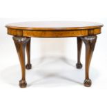 A walnut quarter veneered oval dining table with mahogany cross banding on carved cabriole legs