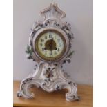 A 19thC French rococo style porcelain cased mantel clock with eight day striking movement.