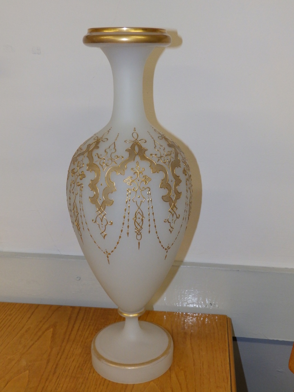 A large 19thC opaque glass vase with gilded decoration.