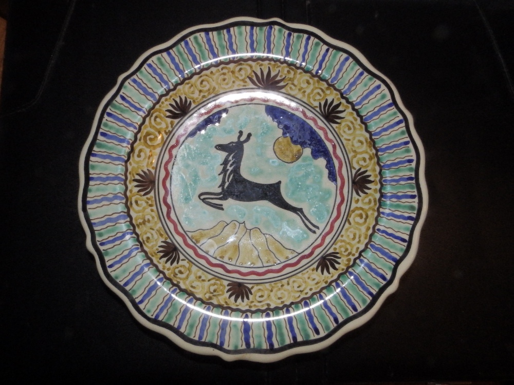 A modern delft wall plate – 'De Delphse Pauw', painted with a leaping stag, 9”” diameter.