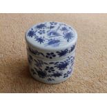 A small Chinese blue & white porcelain cylindrical jar with cover,3.5” high – cover chipped.