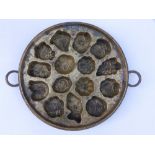 A 19thC circular cast brass chocolate mould.