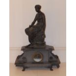 A figural bronze presentation clock on black slate base, with 24 hour dial marked for Ollivant &