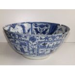 An antique Chinese blue & white porcelain bowl re-stuck from pieces, decorated overall with panels