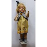 A Lenci fabric girl doll in original blue felt waistcoat on yellow dress, Lenci label to