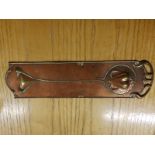 An art nouveau copper finger plate for a door.
