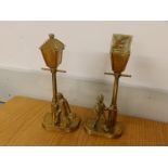 A pair of early 20thC American brass novelty candlesticks modelled as lamp posts with paper boy &