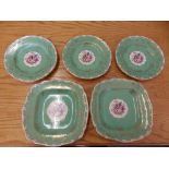 Eight green ground Royal Worcester plates decorated flowers to centre - 'Mona'.