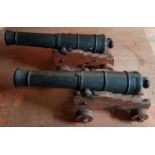 Two antique cast iron cannon, fully bored with touch holes 15", on wooden carriages.