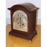 A German chiming mahogany bracket clock with silvered dial by Junghans, Wurtenburg, 15" high.