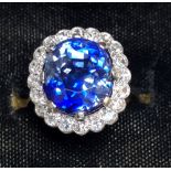 An early 20thC certified natural 8.65 carat Sri-Lankan sapphire & diamond oval cluster ring, in