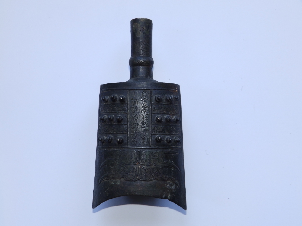 A Chinese bronze bell in the archaic style, 8" high.