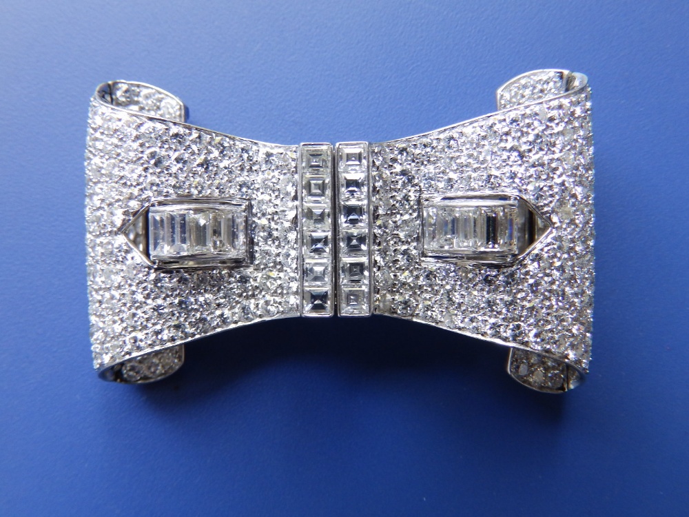 A diamond set scroll double clip brooch in white metal, encrusted with numerous diamonds in square