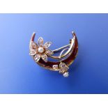 A small enamelled crescent brooch set with diamonds & pearls.