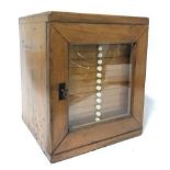 A 19thC travelling slide cabinet, the single glazed door enclosing numerous drawers each to fit 12