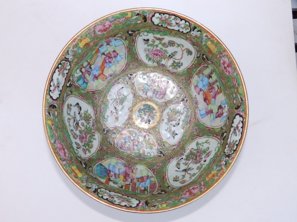 A 19thC Cantonese porcelain punch bowl, decorated with panels depicting butterfies and figures on - Image 2 of 5